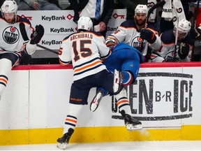 Edmonton Oilers right wing Zack Kassian pulls the helmet off of Colorado Avalanche defenseman Bowen Byram after a check by right wing Josh Archibald in the third period of game two of the Western Conference Final of the 2022 Stanley Cup Playoffs at Ball Arena.