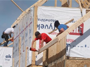 Construction workers are shown framing a house near McHugh Street and Lauzon Road in Windsor on Thursday, May 19, 2022.