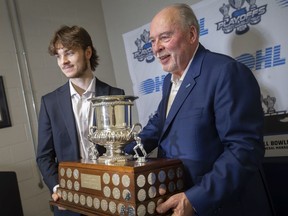 Ontario Hockey League commissioner, David Branch, right, presents Windsor Spitfires' centre Wyatt Johnston with the Red Tilson Trophy after being named the league's most outstanding player.