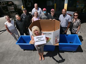 June Muir, CEO of the Unemployed Help Centre, front, and members of her staff are shown at the organization on Thursday, June 23, 2022 where bins are set up to accept Miracle Food Drive donations.