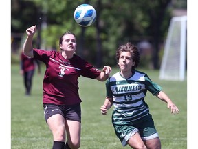 Justine Kinnear, left of Oakville Sainte-Trinitie and Brieann Wightman of Lajeunesse Secondary School battle for the ball during the OFSAA girls' A soccer tournament on Thursday.