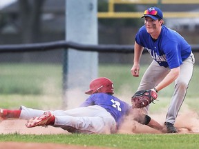Luke Murray, left, of Mitchell Blue Devils gets tagged out at first by Owen Findlay of the Villanova Wildcats during the OFSAA West Regional baseball tournament on Wednesday.