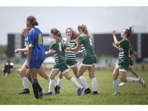 The Lajeunesse Royals celebrate a goal in the first half against Pere de Rene de Galinee in OFSAA Girls 'A' soccer at the Atlas Tube Recreation Centre, on Friday.
