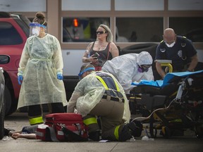Fentanyl continues to take a heavy toll on local streets. Here, EMS paramedics and Windsor firefighters work on a male patient suspected of having an overdose from fentanyl as he lies on the pavement outside Rally Auto Service on the corner of Marentette Avenue and Tecumseh Road East on May 28, 2020.