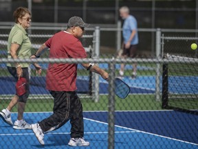 People flock to the courts for pickleball games during the grand opening of Zekelman Pickleball Courts at Lacasse Park on Thursday, June 9, 2022.
