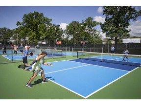 People flock to the courts for pickleball games during the grand opening of Zekelman Pickleball Courts at Lacasse Park on Thursday, June 9, 2022.