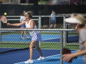 People flock to the courts for pickleball games during the grand opening of Zekelman Pickleball Courts at Lacasse Park on Thursday, June 9, 2022.