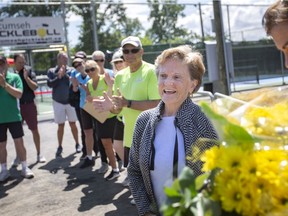 Barbara Dean, who introduced pickleball to the region in 2009 when she started a league at the Riverside Sport Centre, is recognized with a bouquet of flowers during the opening of the Zekelman Pickleball courts at Lacasse Park on Thursday, June 9, 2022.