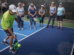 Terry Marais teaches pickleball lessons during the grand opening of the Zekelman Pickleball Courts at Lacasse Park on Thursday, June 9, 2022.