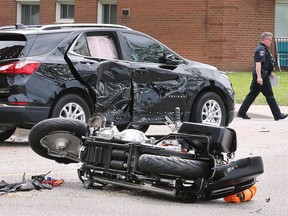 A Windsor police officer is shown at the scene of a serious collision between a motorcycle and a compact SUV on Wednesday, June 1, 2022. The accident occurred at approximately 1 p.m. near the intersection of Riverside Drive West and Bridge Avenue. Riverside Drive was shut down for several hours in both directions between Rankin and Campbell avenues.
