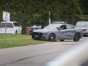 A LaSalle Police cruiser patrols the parking lot surrounding Sandwich Secondary School on June 14, 2022, after an unspecified threat was received at the school.