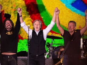 Dave Grohl, Paul McCartney and Bruce Springsteen salute the fans at the Glastonbury Festival in Somerset, England, Saturday, June 25, 2022.