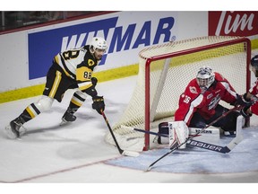 WINDSOR, ONTARIO:. JUNE 10, 2022 - Hamilton's Mark Duarte tries to get the puck past Windsor's Mathius Onuska on a wrap around in game 4 of the OHL finals between the Windsor Spitfires and the Hamilton Bulldogs at the WFCU Centre, on Friday, June 10, 2022.