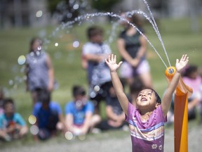 Students from both W.J. Langlois Catholic and William G. Davis public elementary schools enjoy the newly installed splash pad at Fountainebleau Park, on Friday, June 17, 2022.