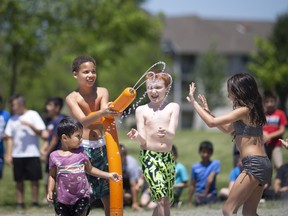 Students from both W.J. Langlois Catholic Elementary School and William G. Davis Elementary School enjoy the newly installed splash pad at Fountainebleau Park on Friday, June 17, 2022.