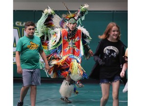Students join in as D.J. White, a traditional dancer from Walpole Island, is shown during Friday's opening of the 1st Annual Alumni & Student Pow Wow at the St. Clair College SportsPlex in Windsor on June 3, 2022.