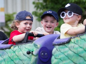 Kids ride a dragon-shaped roller coaster at the LaSalle Strawberry Festival on Sunday, June 12, 2022.