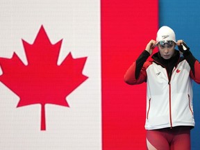 Penny Oleksiak of Canada walks onto the pool deck for her women's 200-meter freestyle semifinal at the 2020 Summer Olympics, Tuesday, July 27, 2021, in Tokyo, Japan. Oleksiak has withdrawn Canada's swim team from the 2022 Commonwealth Games in Birmingham, England.