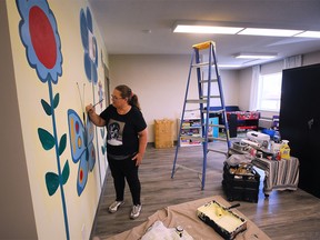 Artist Debbie Kay paints a mural in the children’s recreational room at the Welcome Centre Shelter for Women and Families on Thursday, June 23, 2022.