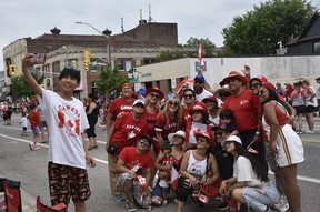 A giant selfie for a giant parade — red and white dominated the fashion and the flags among parade participants and spectators.