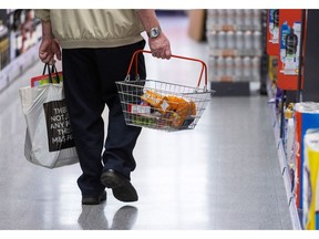 A customer carries a basket of food items at an Iceland Foods Ltd. supermarket in Christchurch, UK, on Wednesday, June 15, 2022.