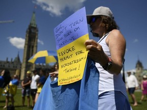 Supporters of Ukraine hold a rally against the Canadian government’s decision to send repaired parts of a Russian natural gas pipeline back to Germany, on Parliament Hill in Ottawa, Sunday, July 17, 2022.