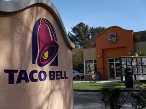 A sign is posted in front of a Taco Bell restaurant on February 22, 2018. (Photo by Justin Sullivan/Getty Images)