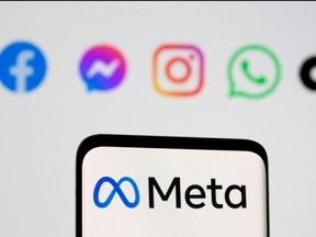 Facebook's new rebrand logo Meta is seen on smartpone in front of displayed logo of Facebook, Messenger, Intagram, and Whatsapp in this illustration picture taken Oct. 28, 2021.