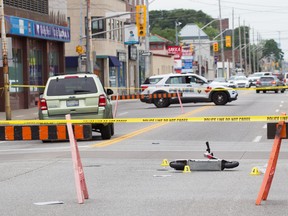 A Bird scooter lies on its side after a collision with a Ford Escape in downtown Windsor on July 23, 2022.