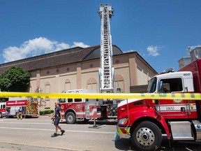 Windsor firefighters deploy an aerial platform due to sightings of smoke on the roof of the old Windsor Arena at 572 McDougall St. on July 14, 2022.