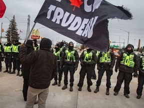 Protesters attempting to blockade the Ambassador Bridge confront police officers in Windsor on Feb. 12, 2022.