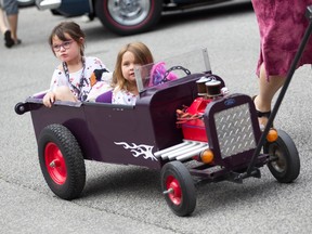 Madison, age six (left) and Amelia Racette, age 4, take a ride down Dalhousie Street in Amherstburg during the Amherstburg’s Gone Car Crazy Show on Sunday, July 24, 2022.
