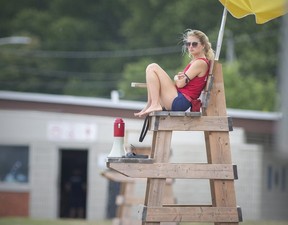 A Windsor lifeguard is shown keeping a watchful eye out on the swim action at Sand Point Beach.  (DAX MELMER/Postmedia Network)