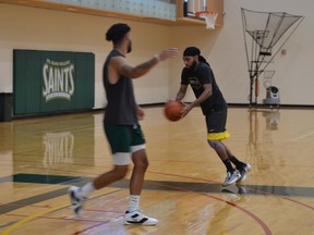 St. Clair College student Jared Hayes, left, and friend Manroop Gill, a Wayne State University graduate, warm up for their 3x3 match at the Hoops of Hope basketball fundraiser Saturday, July 9, 2022, at St. Clair College. The fundraiser for the Downtown Mission was organized by students in the events management program.