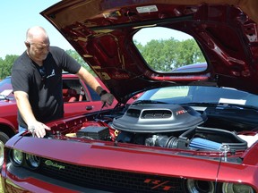 Ron Reaume looks under the hood of his 2022 Dodge Challenger RT shaker wide-body scat pack 392 Sunday, July 10, 2022, at the Ciociaro Club's 40th Sant' Onorio Festival.