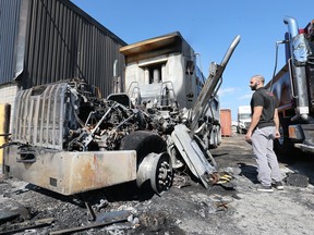 Maroun Eid of Eid Bros. Trucking checks out a fire damage dump truck at the Windsor company on Monday, July 18, 2022. The fire is suspected to be deliberately set over the weekend.
