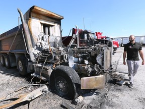 Maroun Eid of Eid Bros Trucking checks out a fire damage dump truck at the Windsor company on Monday, July 18, 2022. The fire is suspected to be deliberately set over the weekend.