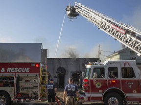 A firefighting aerial platform directs water on a building at 495 Tuscarora St. in Windsor on July 14, 2022.