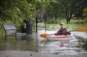 Kayaker Simon Shanfield navigates a swollen and flooding Turkey Creek in LaSalle on Aug. 28, 2020, as the region received a significant amount of rain.