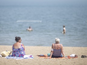 Beachgoers embrace the high temperatures while at Sand Point Beach, on a very hot June 15, 2022. High E. coli counts in the water triggered a health unit warning not to swim until water quality conditions improve.