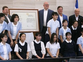 High school students from Japan visit Windsor City Hall on Tuesday, July 26, 2022. They are shown posing for a photo in council chambers with Mayor Drew Dilkens and other dignitaries.