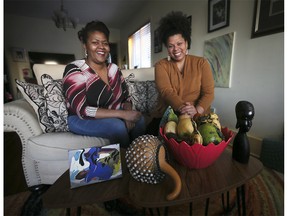 WINDSOR , ONTARIO. DECEMBER 13, 2021 -  Clarese Carter, left, and Christie Nelson from the Family Fuse organization are shown on Monday, December 13, 2021 with items that will be used to celebrate the upcoming Kwanzaa.