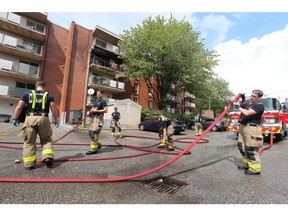 Windsor firefighters are shown at the Barcelona apartment complex in the 8900 block of Wyandotte Street East on Wednesday, July 20, 2022. A fire gutted a unit.