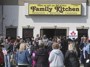 In this April 6, 2021, file photo, anti-lockdown demonstrators are shown in front of the Family Kitchen restaurant in Leamington. The owner has now pleaded guilty to violating provincial pandemic rules and been handed $20,000 in penalties by a Windsor justice of the peace.