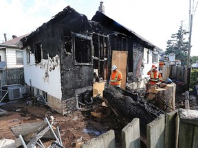 Windsor fire investigators examine the damage to a residence in the 1250 block of McEwan Ave. on July 22, 2022.