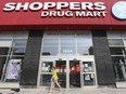 A woman leaves a Shoppers Drug Mart store in Toronto.