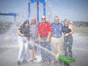 Splash! Lakeshore residents get a new park, while Lakeshore councillors Kelsey Santarosa, left, John Kerr, Len Janisse and Tracey Bailey — with Mayor Tom Bain, second from right — got a good soaking during the grand opening of River Ridge Park on Thursday, July 7, 2022.