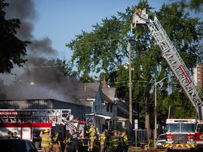 A firefighting aerial platform directs water onto a multi-unit building at 495 Tuscarora St. in Windsor on July 14, 2022.