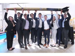 A team of fourth-year students in the University of Windsor's mechanical engineering program hold up their 'Windsoars' rocket - one of the capstone projects on display at the Ed Lumley Centre for Engineering Innovation on July 29, 2022.