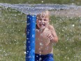 Rory Kearns, 3, cools down at the Forest Glade Optimist Park splash pad on July 5, 2022.
